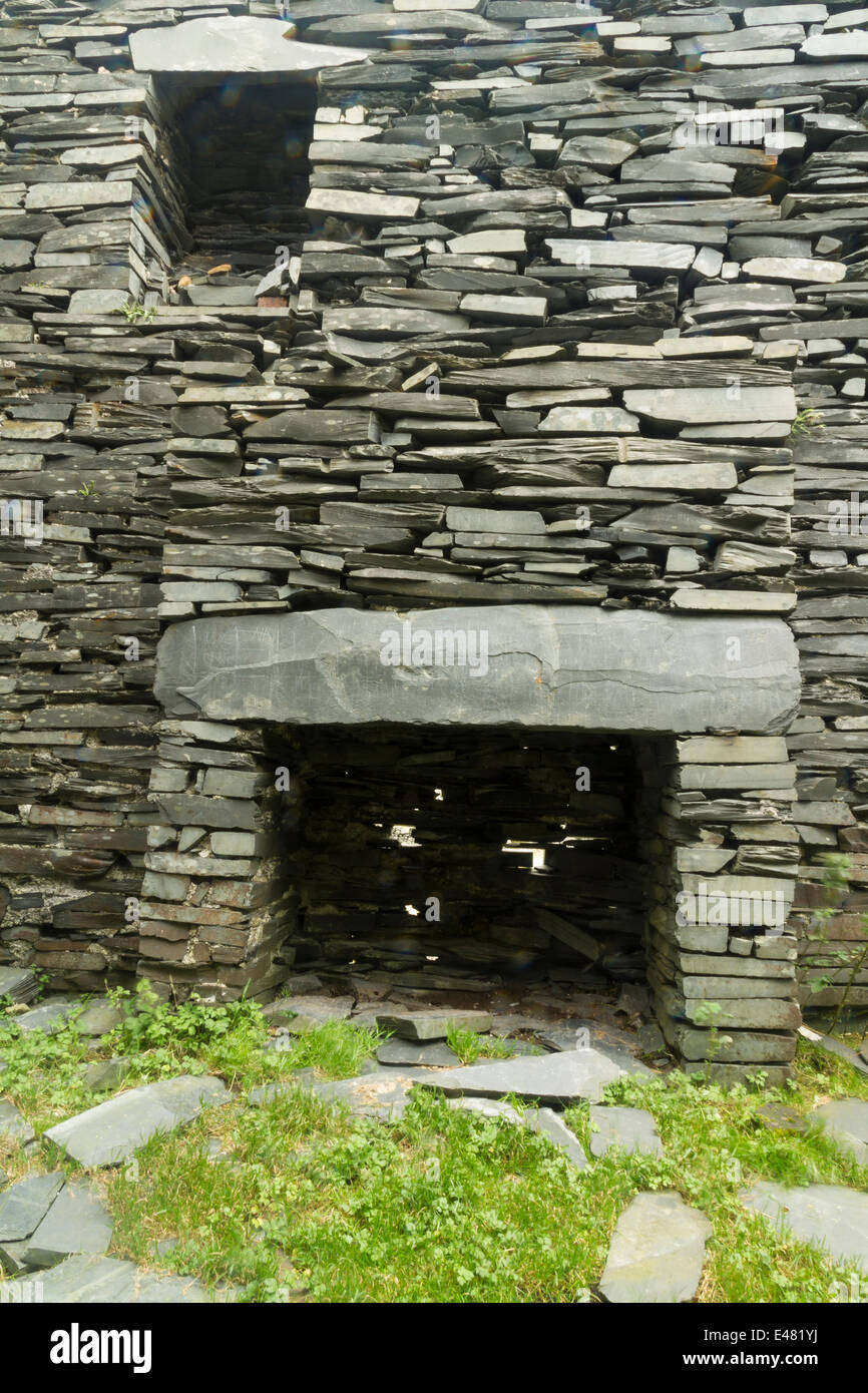 A fireplace in a ruin, with dry stone slate walls. Cwmorthin Terrace