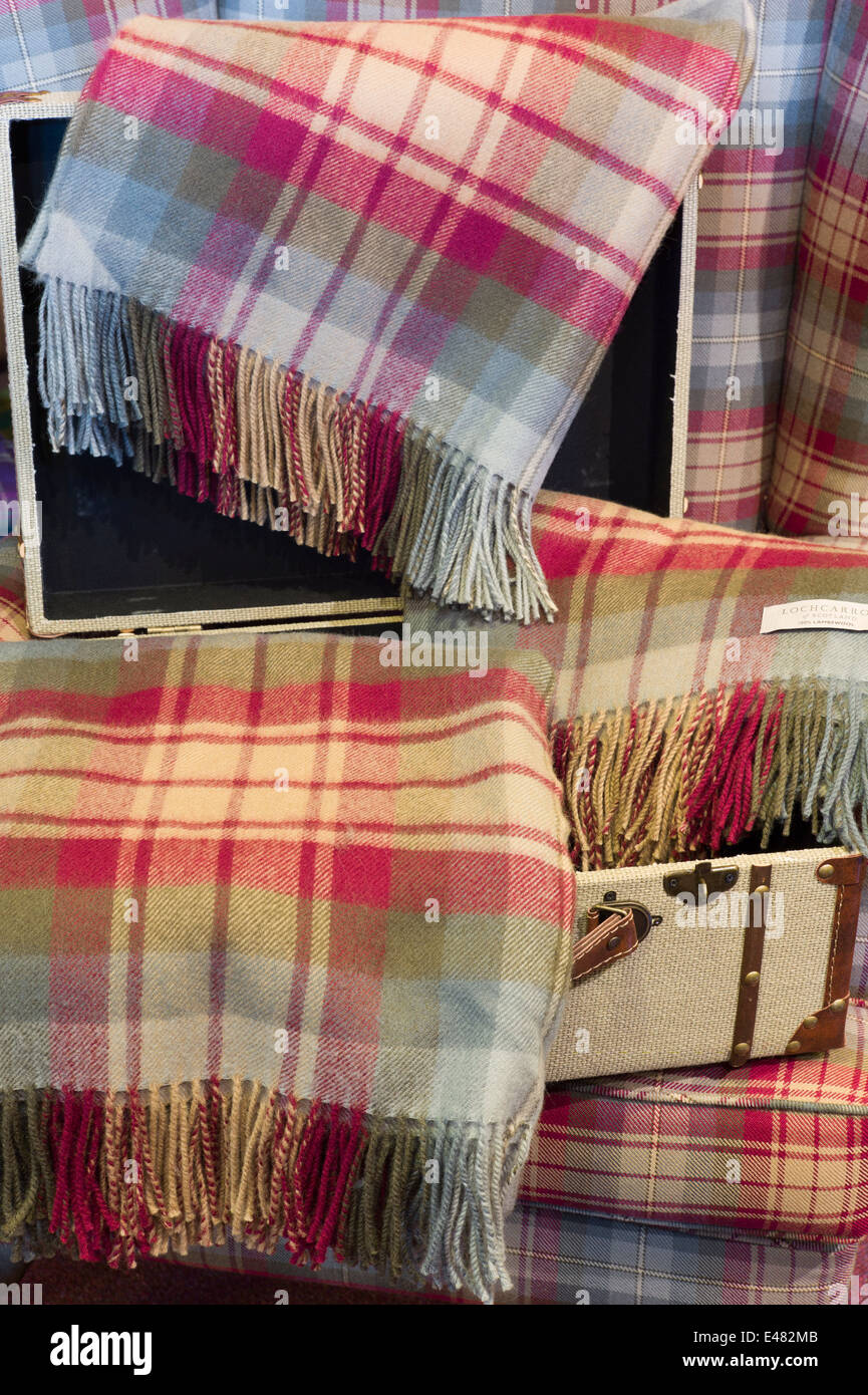 Traditional highland tartan, Auld SCOTLAND, as lambswool throws and scarves at Lochcarron Weavers Shop in Highlands of SCOTLAND Stock Photo