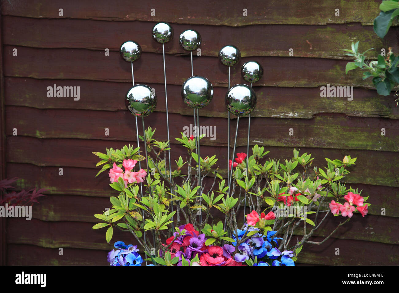 Decorative Metal Spheres In A Terracotta Plant Flower Pot Garden