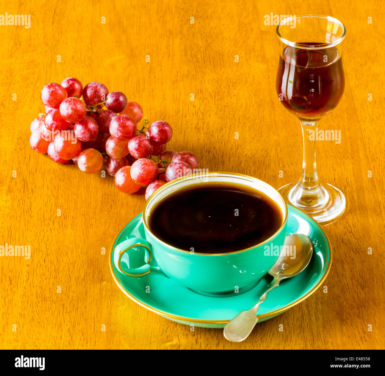 A Cup of strong Black Coffee with a Liqueur and some Grapes Stock Photo