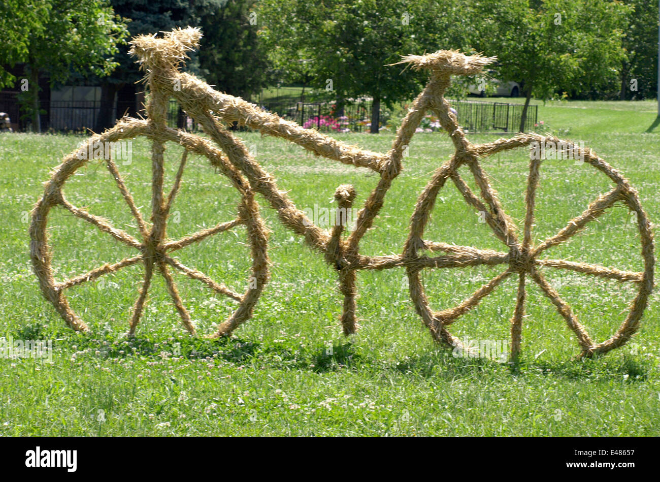 bike sculpture of straw on the lawn Stock Photo Alamy