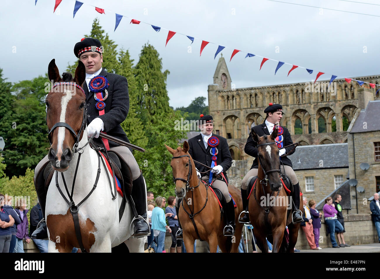 Jedburgh, UK. 05 July 2014 Jethart Callant's Festival 2014 - Redeswire Rideout. Callant John Fraser (Jack) leads the cavalcade. The Jethart Callant's Festival is held annually in the Scottish Border's town of Jedburgh to commemorate the historical skirmish between Scots and English armies, known as the Raid of Redeswire, in 1575. The encounter is often cited as the last battle between the two armies, and is immortalised in the poem by Sir Walter Scott 'The Raid Of The Redeswire'.  (Photo: Rob Gray) Credit:  Rob Gray/Alamy Live News Stock Photo