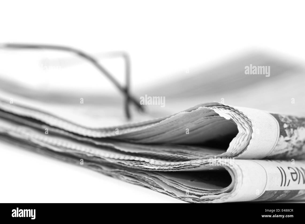 Newspaper  folded up on a white background Stock Photo