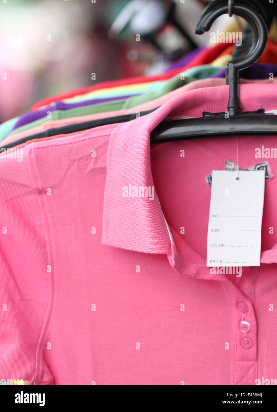 Pink shirt on a hanger in shop. Stock Photo
