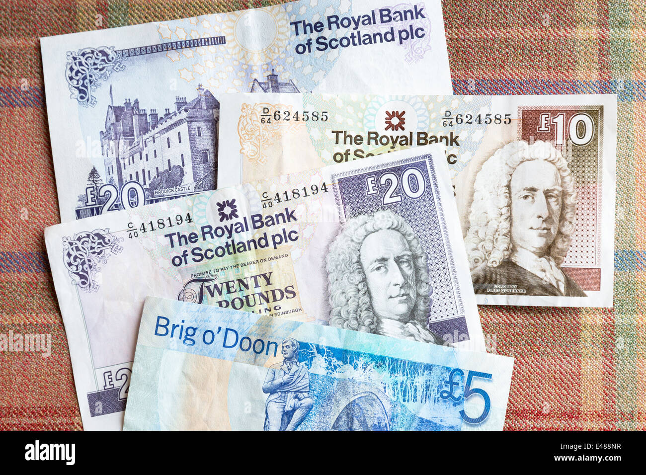Scottish banknotes from The Royal Bank of SCOTLAND £5, £10 £20 on traditional Scottish tartan background Stock Photo