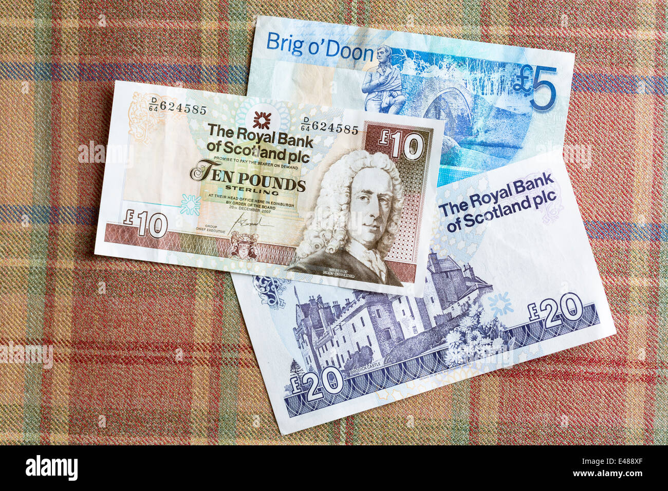 Scottish banknotes from The Royal Bank of SCOTLAND £5, £10 £20 on traditional Scottish tartan background Stock Photo