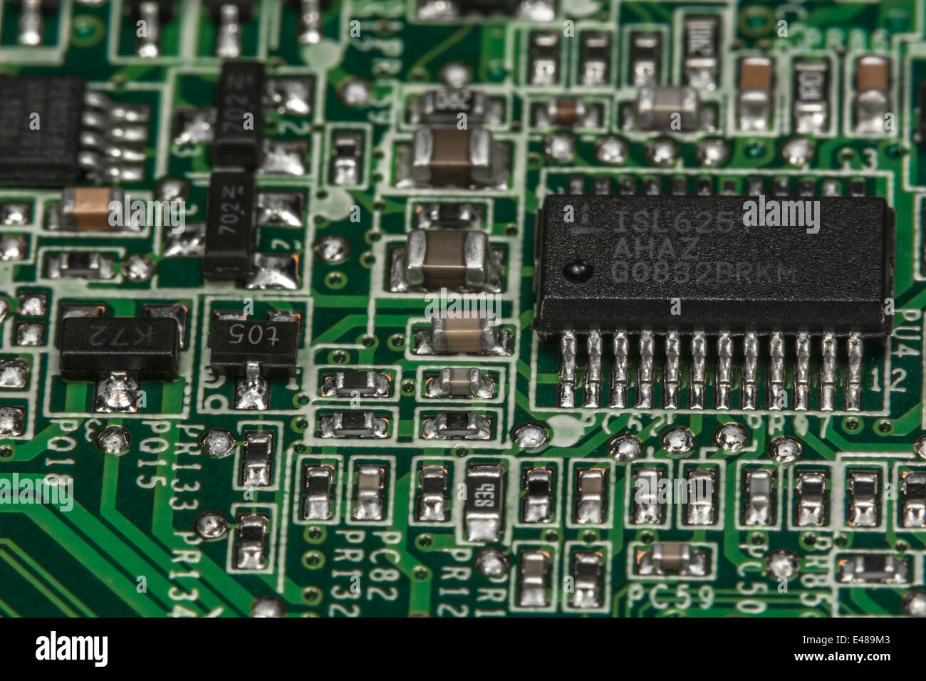 Macro-photo of surface mount (SMT) circuit board showing resistors, capacitors and linking wiring, close up circuit. Focus detail in 'description' Stock Photo
