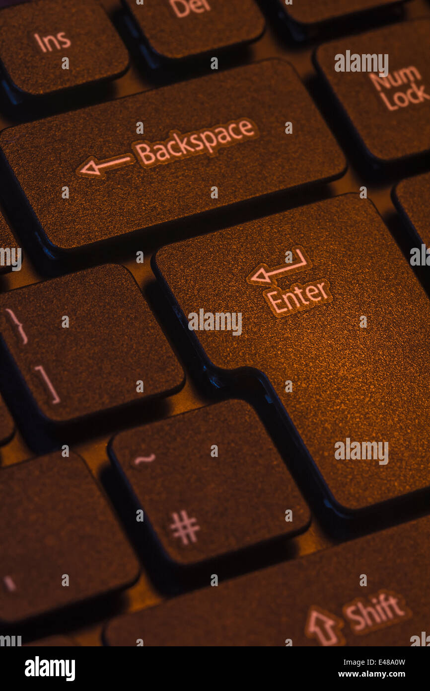 Macro-photo of computer keyboard enter / return key with backspace. Precise focus on 'Enter' lettering. Stock Photo