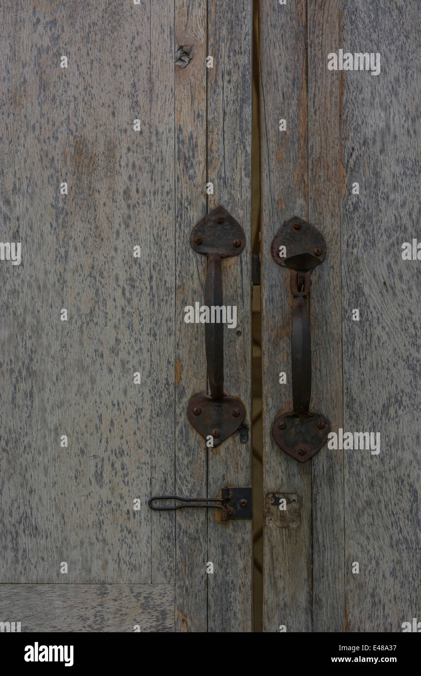 Open data / file access concept. Detail of a garden shed door with slightly rusting iron handles and lock. Stock Photo