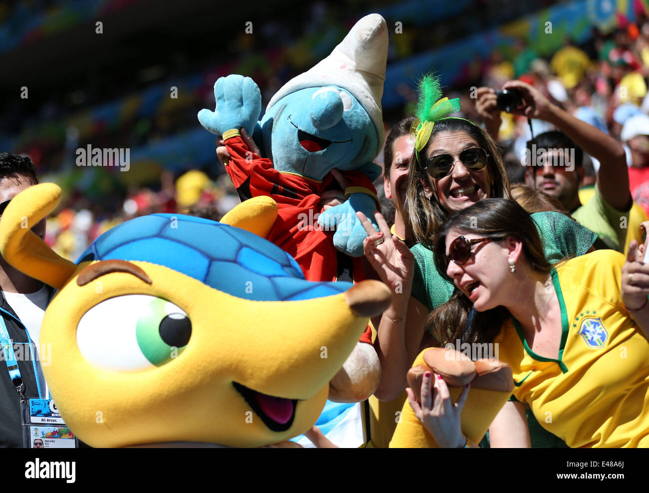 Brasilia, Brazil. 5th July, 2014. Football fans pose with mascot Fuleco prior to a quarter-finals match between Argentina and Belgium of 2014 FIFA World Cup at the Estadio Nacional Stadium in Brasilia, Brazil, on July 5, 2014. Credit:  Li Ming/Xinhua/Alamy Live News Stock Photo