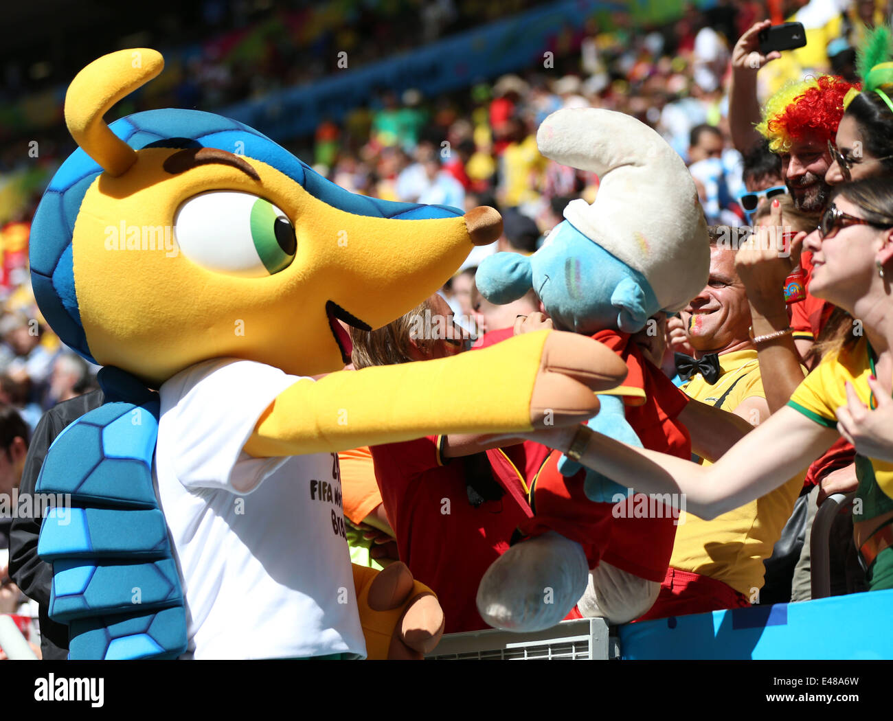 Brasilia, Brazil. 5th July, 2014. Football fans interact with mascot Fuleco prior to a quarter-finals match between Argentina and Belgium of 2014 FIFA World Cup at the Estadio Nacional Stadium in Brasilia, Brazil, on July 5, 2014. Credit:  Li Ming/Xinhua/Alamy Live News Stock Photo