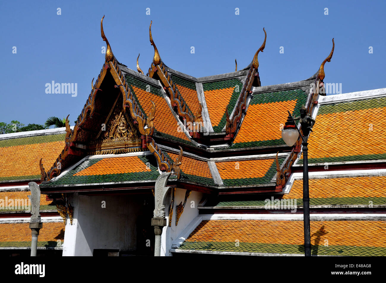 BANGKOK, THAILAND: Step gabled roofs with chofah ornaments over the cloister gallery at Wat Suthat Stock Photo