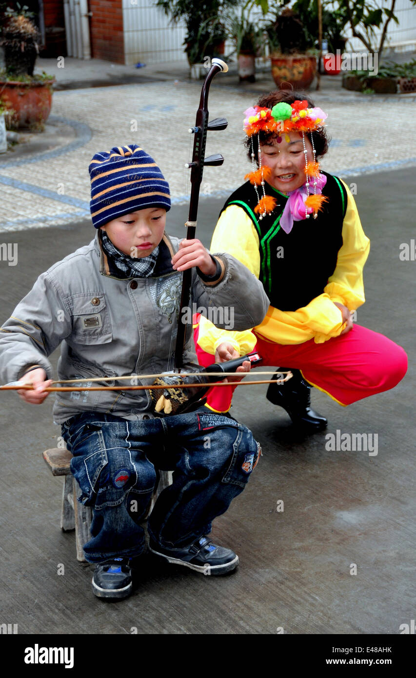 PENGZHOU, CHINA: A little boy playing the Erhu entertains during the Chinese Lunar New Year holidays Stock Photo