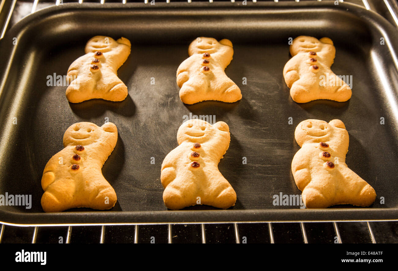 Baking Gingerbread man in the oven. Cooking in the oven. Stock Photo