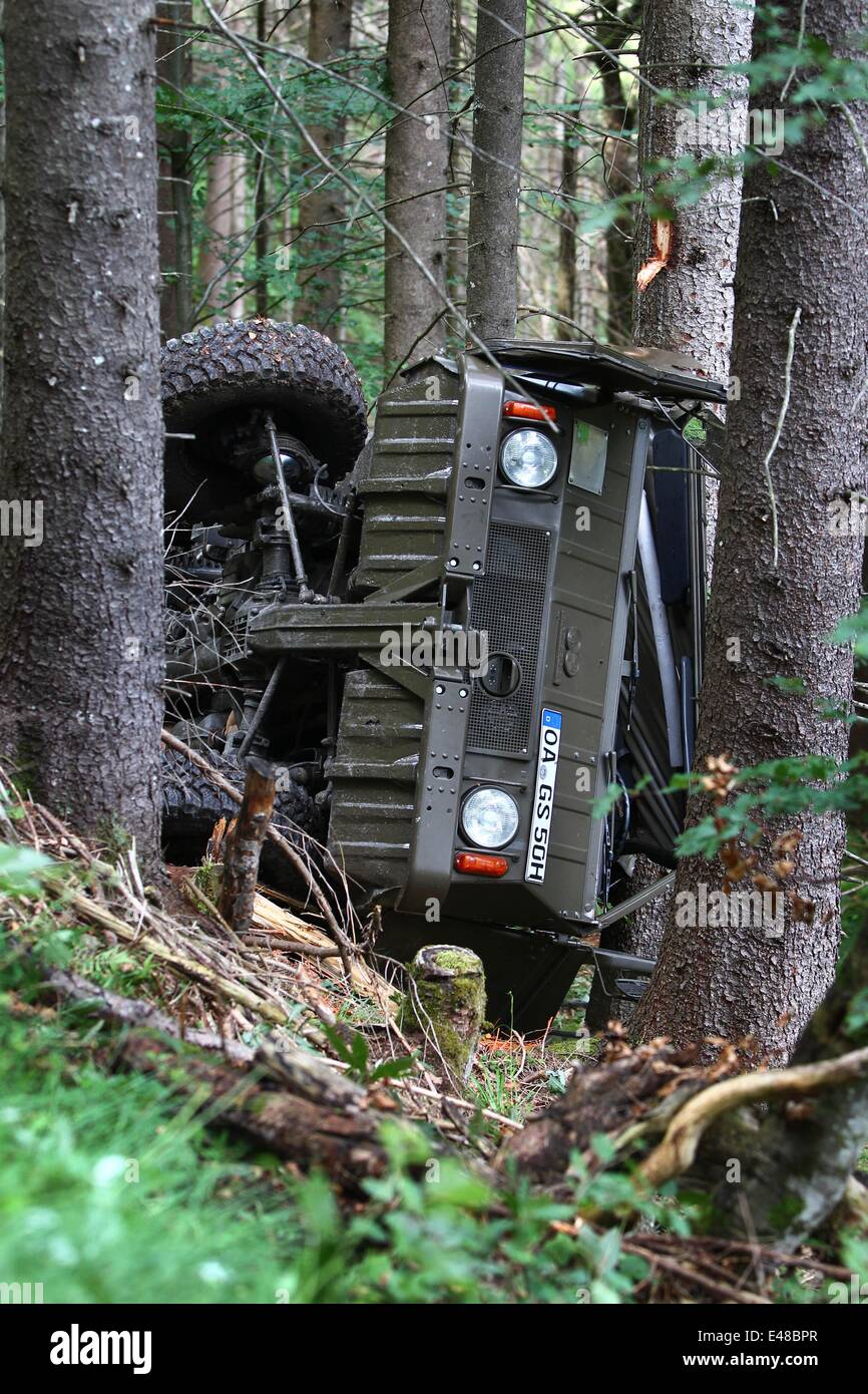 People work to free an SUV in the mountains near Oberstdorf, Germany, 05 July 2014. Several people were in the car when is went off the road and crashed down a cliff. One person was killed in the accident. Photo: KARL-JOSEF HILDENBRAND/dpa Stock Photo