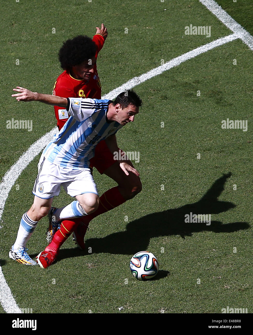 Brasilia, Brazil. 5th July, 2014. Argentina's Lionel Messi (front) vies with Belgium's Marouane Fellaini during a quarter-finals match between Argentina and Belgium of 2014 FIFA World Cup at the Estadio Nacional Stadium in Brasilia, Brazil, on July 5, 2014. Credit:  Liu Bin/Xinhua/Alamy Live News Stock Photo