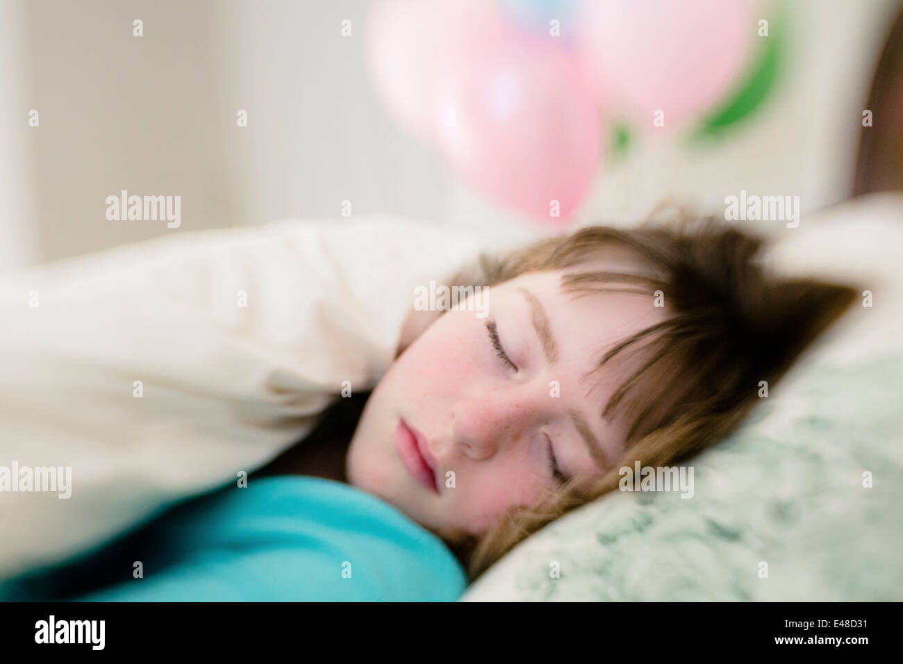 Teenage girl (13-15) sleeping in bed Stock Photo