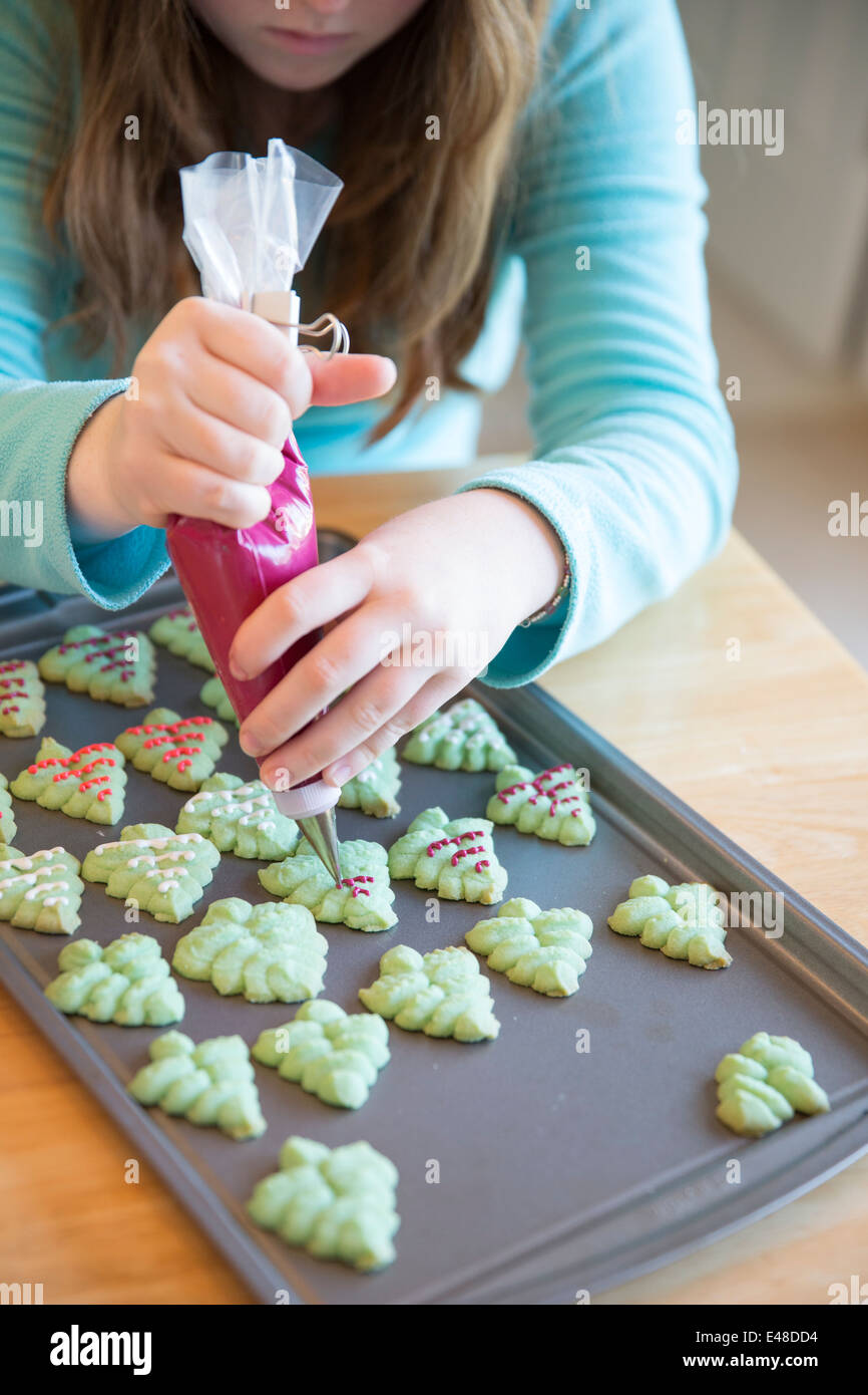 Girl (13-15) decorating cookies Stock Photo