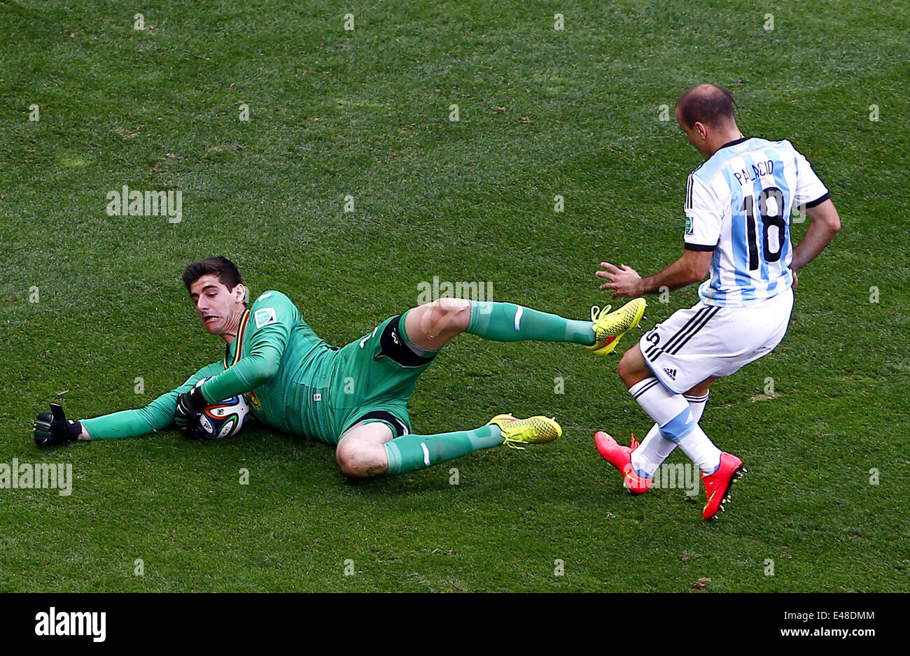 Brasilia, Brazil. 5th July, 2014. Belgium's goalkeeper Thibaut Courtois (L) blocks the ball during a quarter-finals match between Argentina and Belgium of 2014 FIFA World Cup at the Estadio Nacional Stadium in Brasilia, Brazil, on July 5, 2014. Argentina won 1-0 over Belgium and qualified for the semi-finals. Credit:  Liu Bin/Xinhua/Alamy Live News Stock Photo