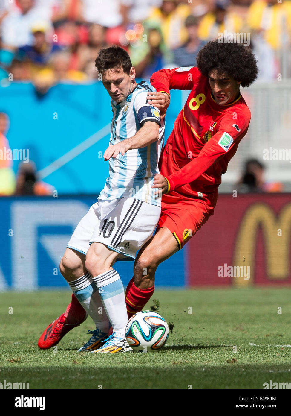 Brasilia, Brazil. 5th July, 2014. Argentina's Lionel Messi (L) vies with Belgium's Marouane Fellaini during a quarter-finals match between Argentina and Belgium of 2014 FIFA World Cup at the Estadio Nacional Stadium in Brasilia, Brazil, on July 5, 2014. Argentina won 1-0 over Belgium and qualified for the semi-finals. Credit:  Qi Heng/Xinhua/Alamy Live News Stock Photo