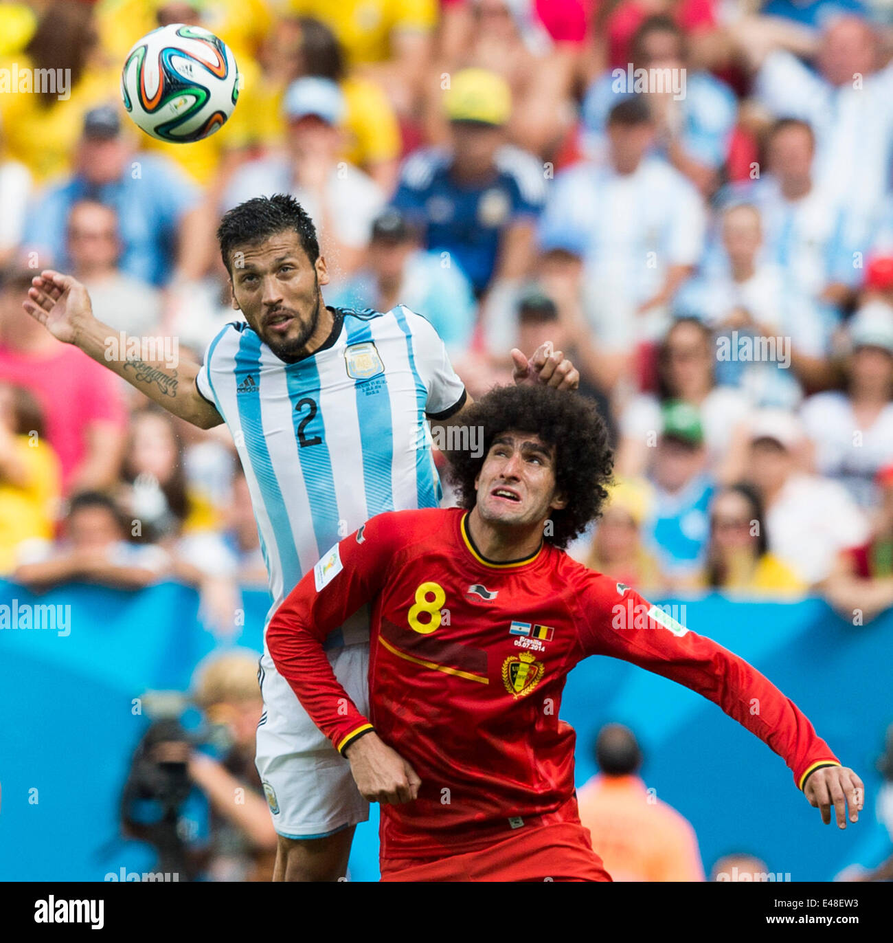 Brasilia, Brazil. 5th July, 2014. Argentina's Ezequiel Garay (L) vies with Belgium's Marouane Fellaini during a quarter-finals match between Argentina and Belgium of 2014 FIFA World Cup at the Estadio Nacional Stadium in Brasilia, Brazil, on July 5, 2014. Argentina won 1-0 over Belgium and qualified for the semi-finals. Credit:  Qi Heng/Xinhua/Alamy Live News Stock Photo