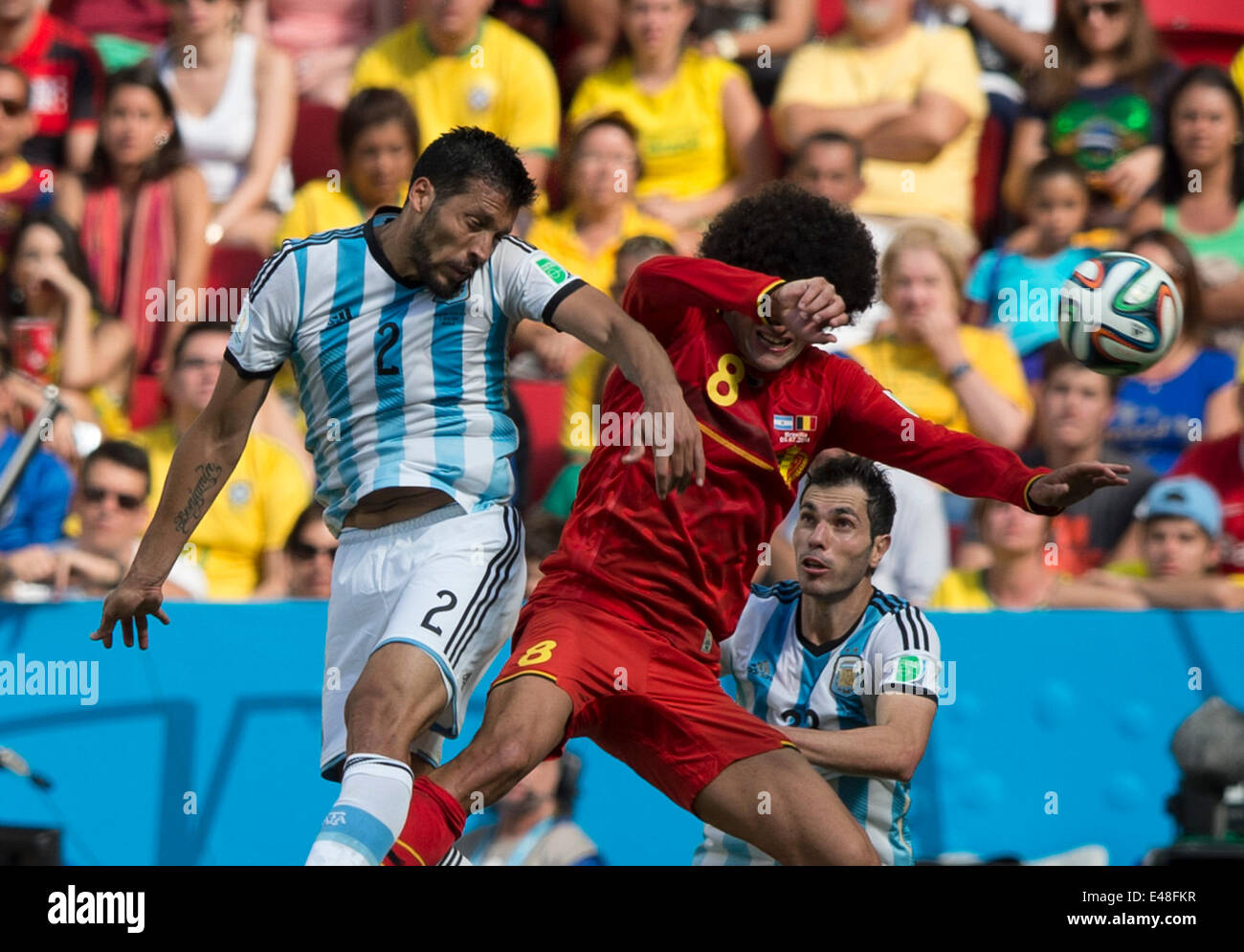 Brasilia, Brazil. 5th July, 2014. Belgium's Marouane Fellaini (R, front) vies with Argentina's Ezequiel Garay (L, front) during a quarter-finals match between Argentina and Belgium of 2014 FIFA World Cup at the Estadio Nacional Stadium in Brasilia, Brazil, on July 5, 2014. Argentina won 1-0 over Belgium and qualified for the semi-finals. Credit:  Qi Heng/Xinhua/Alamy Live News Stock Photo