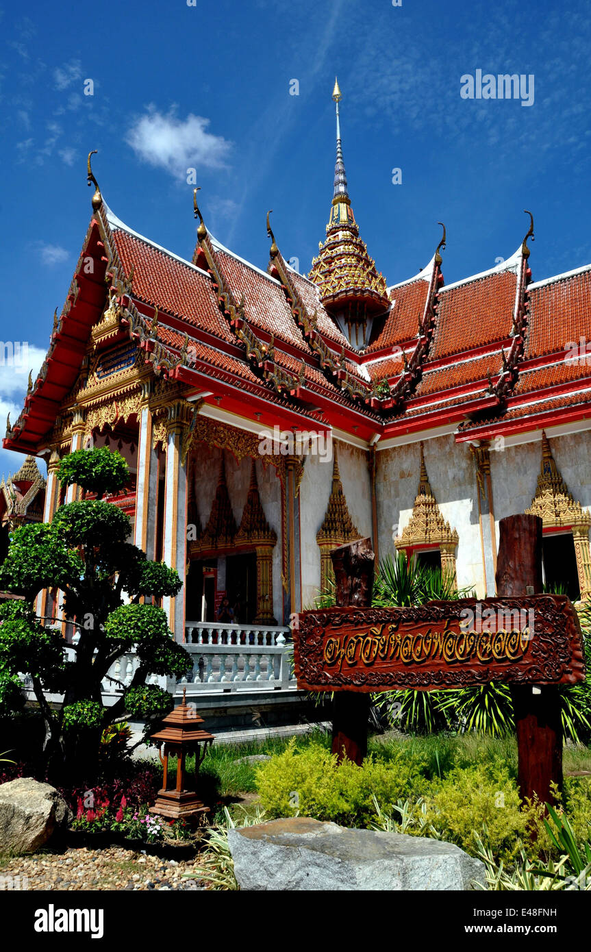 PHUKET, THAILAND: Ubosot Sanctuary Hall with its steeply pitched, gabled roofs, gilded chofah ornaments, and gild Stock Photo