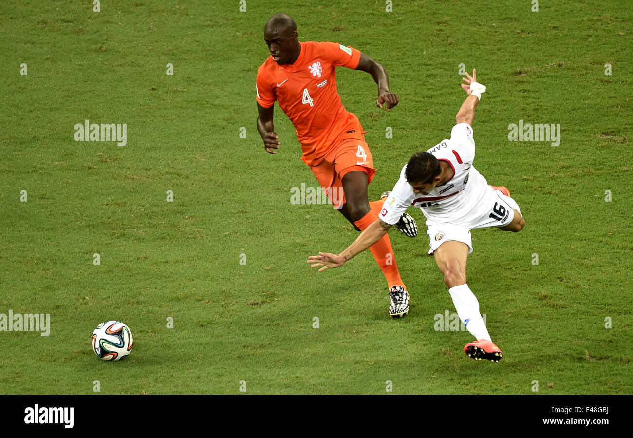 Salvador, Brazil. 5th July, 2014. Netherlands' Bruno Martins Indi (L) vies with Costa Rica's Christian Gamboa during a quarter-finals match between Netherlands and Costa Rica of 2014 FIFA World Cup at the Arena Fonte Nova Stadium in Salvador, Brazil, on July 5, 2014. Credit:  Yang Lei/Xinhua/Alamy Live News Stock Photo