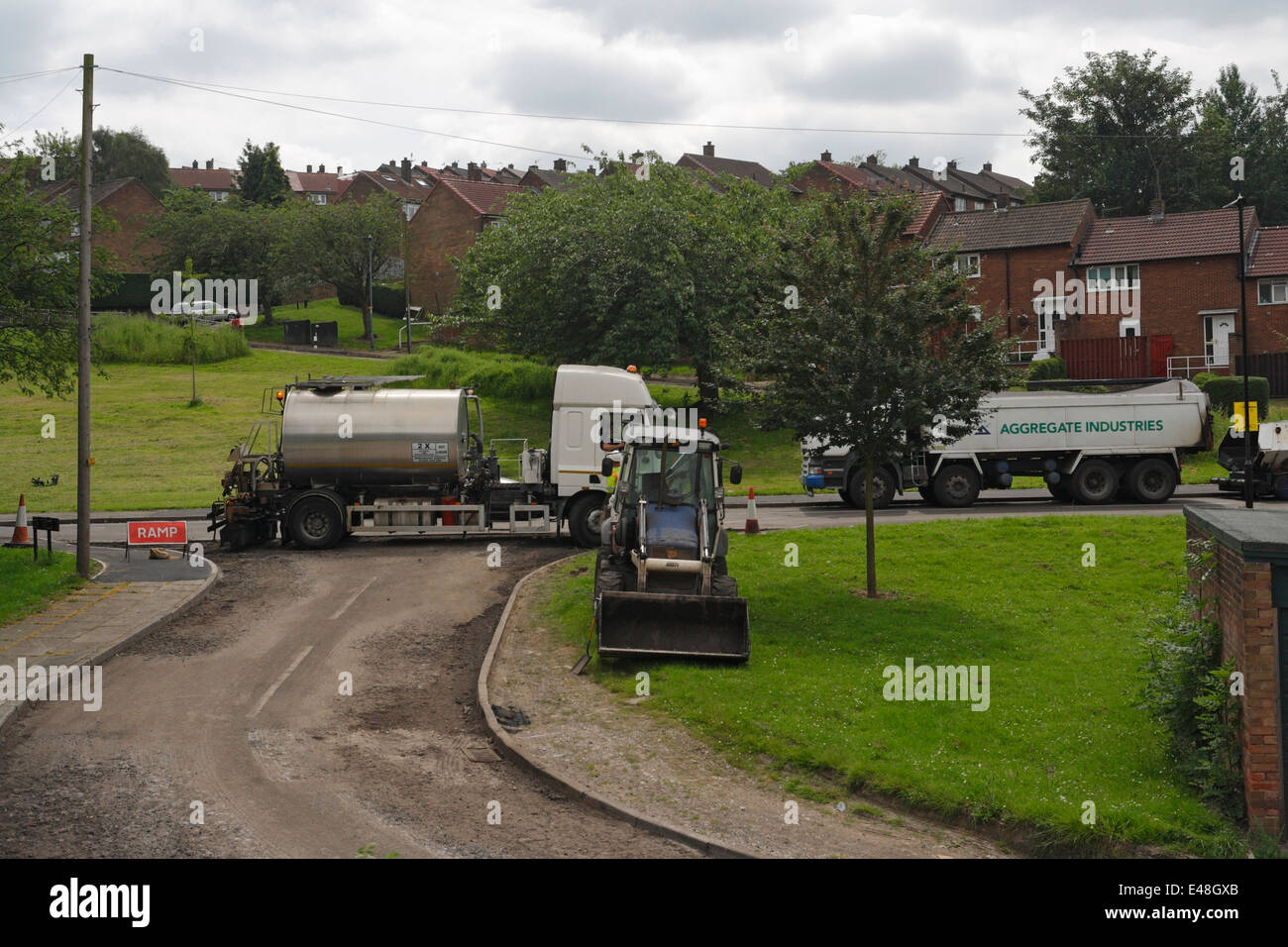 Road resurfacing work in a suburban street in Sheffield England road repairs Stock Photo