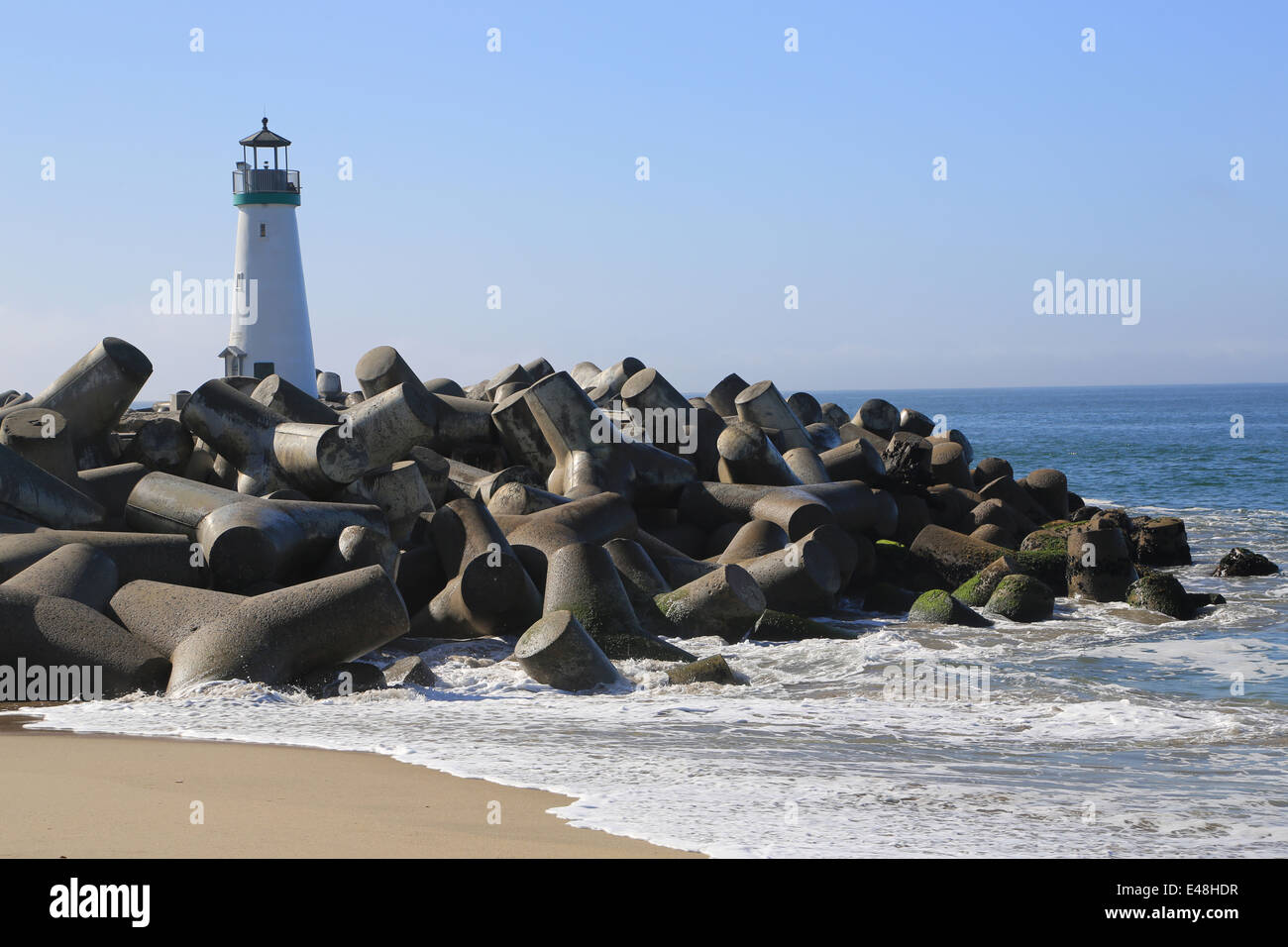 Lady walking on seabright beach, on east cliff near Breakwater
