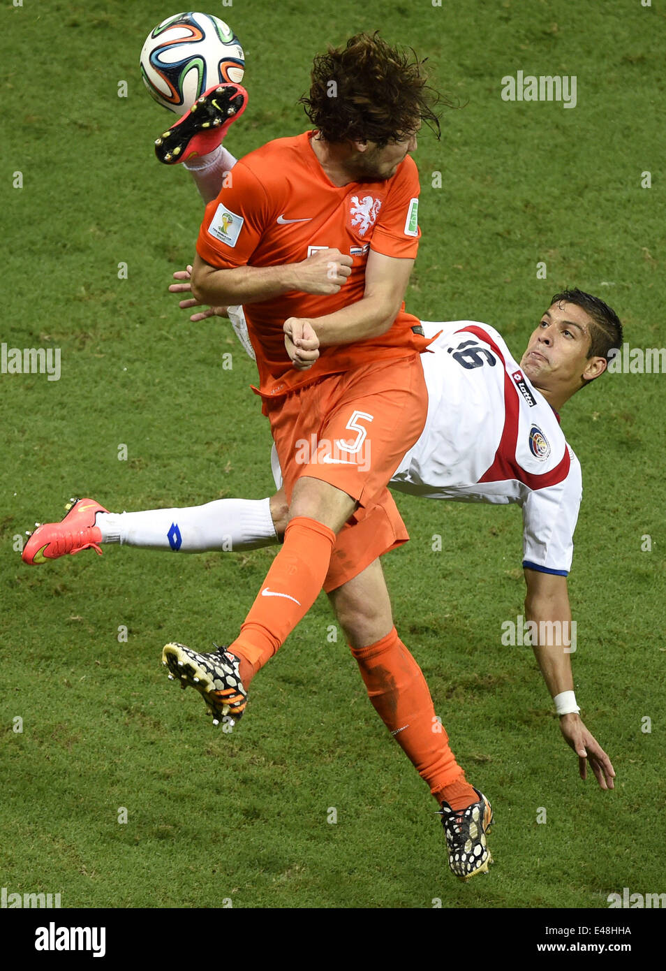 Salvador, Brazil. 5th July, 2014. Netherlands' Daley Blind (front) vies with Costa Rica's Christian Gamboa during a quarter-finals match between Netherlands and Costa Rica of 2014 FIFA World Cup at the Arena Fonte Nova Stadium in Salvador, Brazil, on July 5, 2014. Credit:  Yang Lei/Xinhua/Alamy Live News Stock Photo