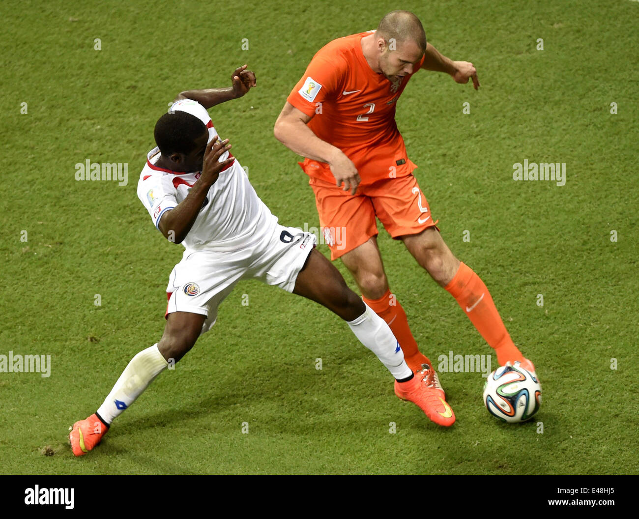 Salvador, Brazil. 5th July, 2014. Netherlands' Ron Vlaar (R) vies with Costa Rica's Joel Campbell during a quarter-finals match between Netherlands and Costa Rica of 2014 FIFA World Cup at the Arena Fonte Nova Stadium in Salvador, Brazil, on July 5, 2014. Credit:  Yang Lei/Xinhua/Alamy Live News Stock Photo