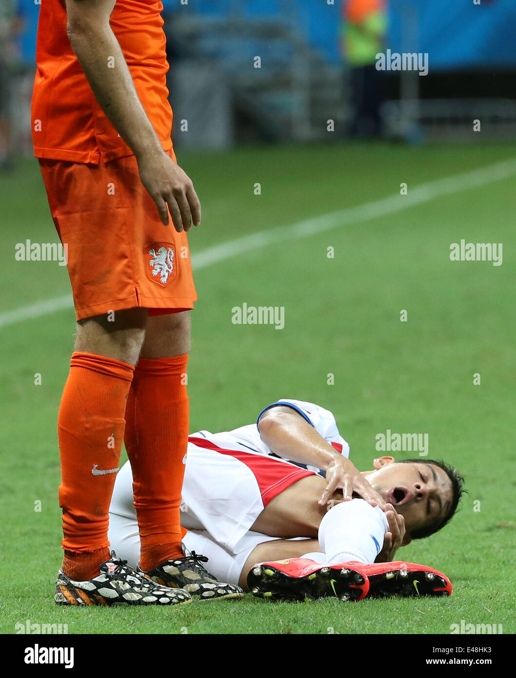 Salvador, Brazil. 5th July, 2014. Costa Rica's Christian Gamboa (R) falls down during a quarter-finals match between Netherlands and Costa Rica of 2014 FIFA World Cup at the Arena Fonte Nova Stadium in Salvador, Brazil, on July 5, 2014. Credit:  Cao Can/Xinhua/Alamy Live News Stock Photo