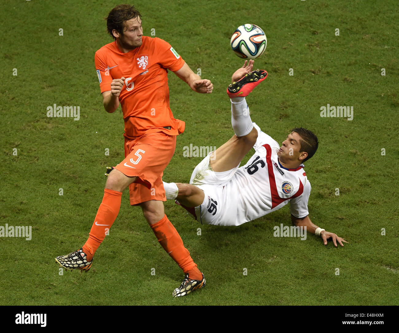 Salvador, Brazil. 5th July, 2014. Netherlands' Daley Blind (L) vies with Costa Rica's Christian Gamboa during a quarter-finals match between Netherlands and Costa Rica of 2014 FIFA World Cup at the Arena Fonte Nova Stadium in Salvador, Brazil, on July 5, 2014. Credit:  Yang Lei/Xinhua/Alamy Live News Stock Photo