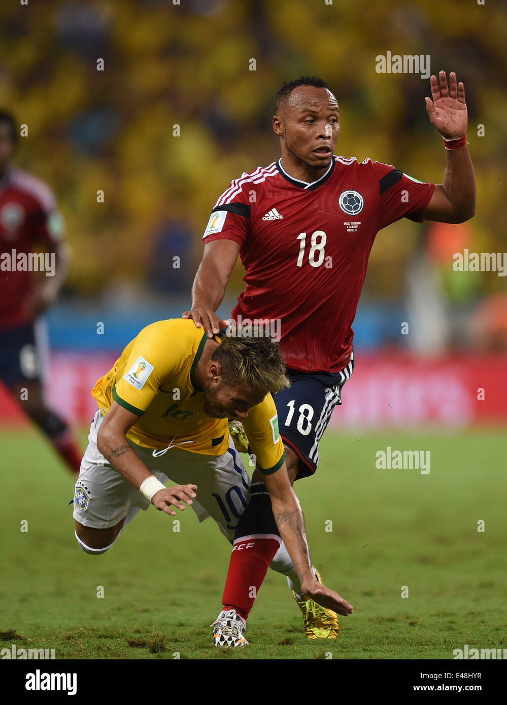Fortaleza, Brazil. 04th July, 2014. Neymar (L) of Brazil goes down after the tackle from Juan Zuniga of Colombia during the FIFA World Cup 2014 quarter final match soccer between Brazil and Colombia at the Estadio Castelao in Fortaleza, Brazil, 04 July 2014. Credit:  Action Plus Sports/Alamy Live News Stock Photo