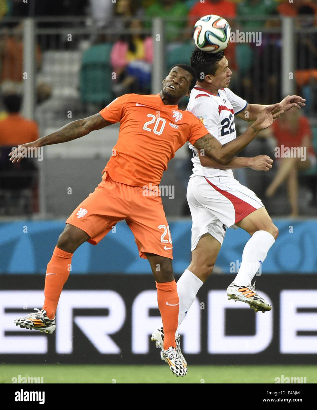 Salvador, Brazil. 5th July, 2014. Netherlands's Georginio Wijnaldum competes for a header with Costa Rica's Jose Miguel Cubero during a quarter-finals match between Netherlands and Costa Rica of 2014 FIFA World Cup at the Arena Fonte Nova Stadium in Salvador, Brazil, on July 5, 2014. Netherlands won 4-3 on penalties over Costa Rica after a 0-0 tie and qualified for semi-finals on Saturday. Credit:  Lui Siu Wai/Xinhua/Alamy Live News Stock Photo
