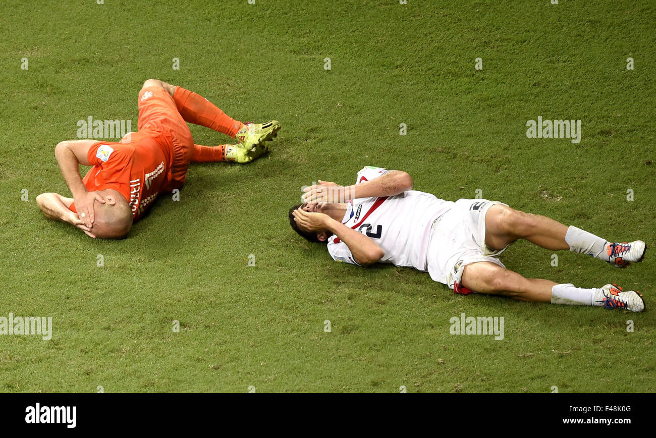 Salvador, Brazil. 5th July, 2014. Netherlands' Arjen Robben (L) and Costa Rica's Johnny Acosta lie on the ground during a quarter-finals match between Netherlands and Costa Rica of 2014 FIFA World Cup at the Arena Fonte Nova Stadium in Salvador, Brazil, on July 5, 2014. Credit:  Yang Lei/Xinhua/Alamy Live News Stock Photo