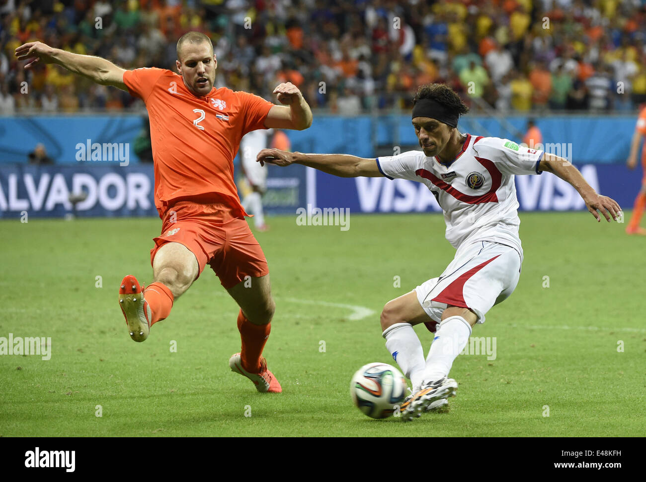 Salvador, Brazil. 5th July, 2014. Netherlands' Ron Vlaar vies with Costa Rica's Christian Bolanos during a quarter-finals match between Netherlands and Costa Rica of 2014 FIFA World Cup at the Arena Fonte Nova Stadium in Salvador, Brazil, on July 5, 2014. Netherlands won 4-3 on penalties over Costa Rica after a 0-0 tie and qualified for semi-finals on Saturday. Credit:  Lui Siu Wai/Xinhua/Alamy Live News Stock Photo