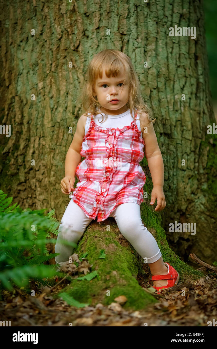 Little girl in the forest Stock Photo - Alamy