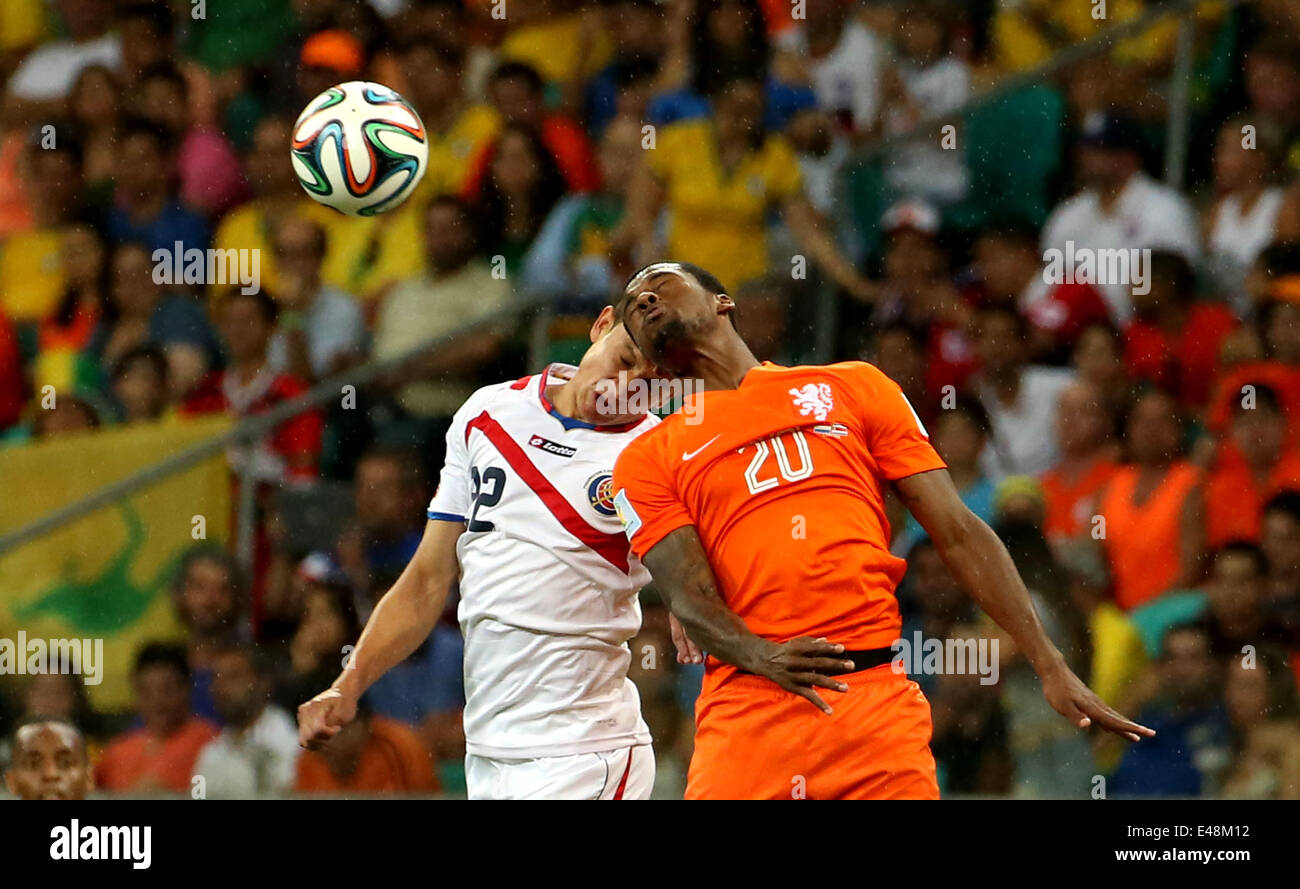 Salvador, Brazil. 5th July, 2014. Netherlands' Georginio Wijnaldum (R) competes for a header with Costa Rica's Jose Miguel Cubero during a quarter-finals match between Netherlands and Costa Rica of 2014 FIFA World Cup at the Arena Fonte Nova Stadium in Salvador, Brazil, on July 5, 2014. Netherlands won 4-3 on penalties over Costa Rica after a 0-0 tie and qualified for semi-finals on Saturday. Credit:  Cao Can/Xinhua/Alamy Live News Stock Photo