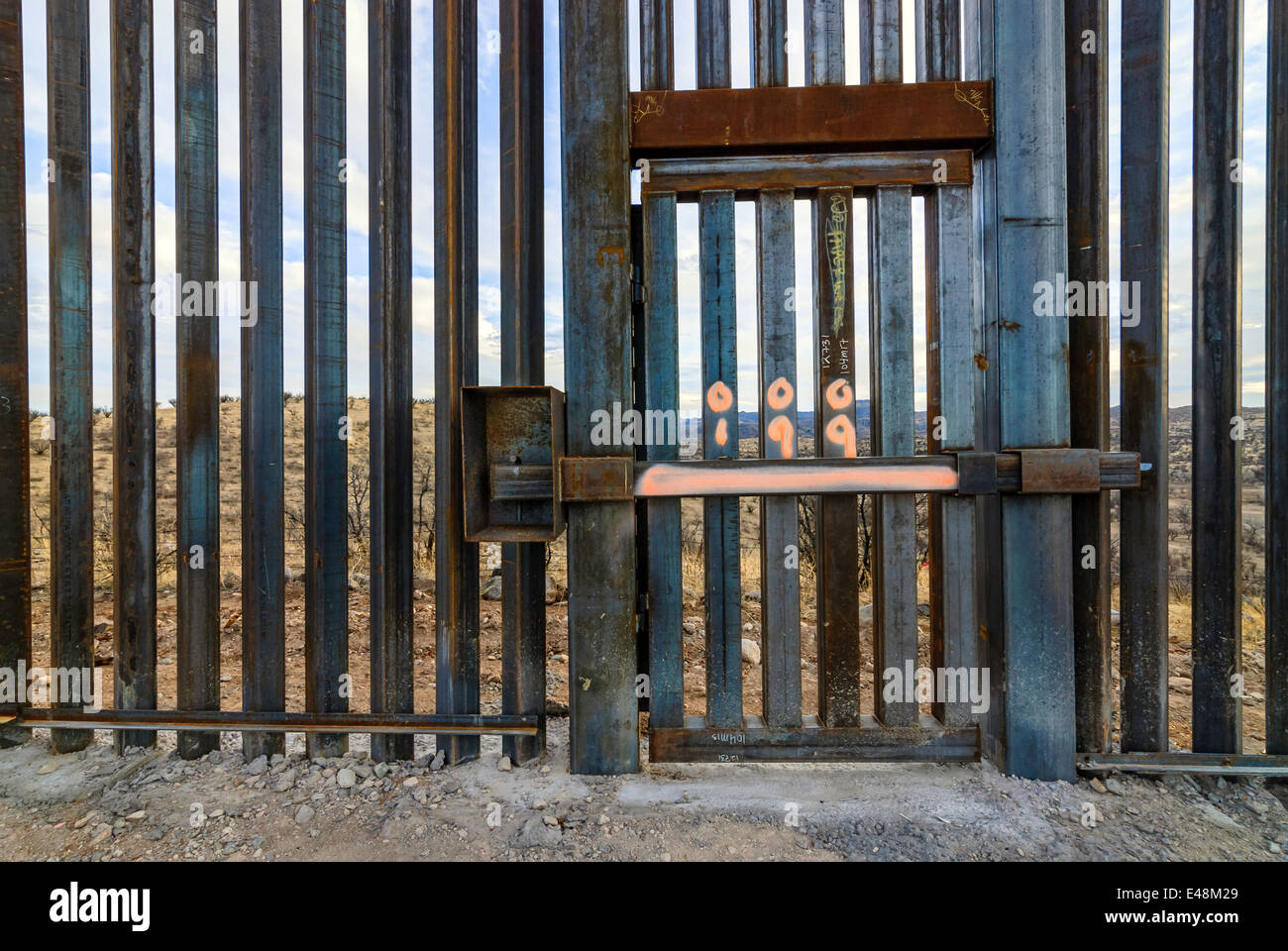 Locked gate in US Border Fence, east of Nogales Arizona USA, constructed autumn and winter of 2008, viewed from US side Stock Photo