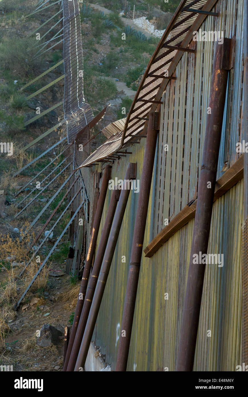 Detail of US border fence in Nogales Arizona USA, looking southeast toward Sonora Mexico Stock Photo