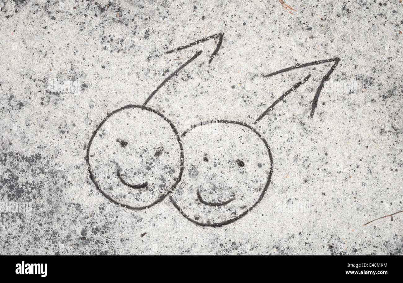 closeup to male couple drawing on sand background Stock Photo