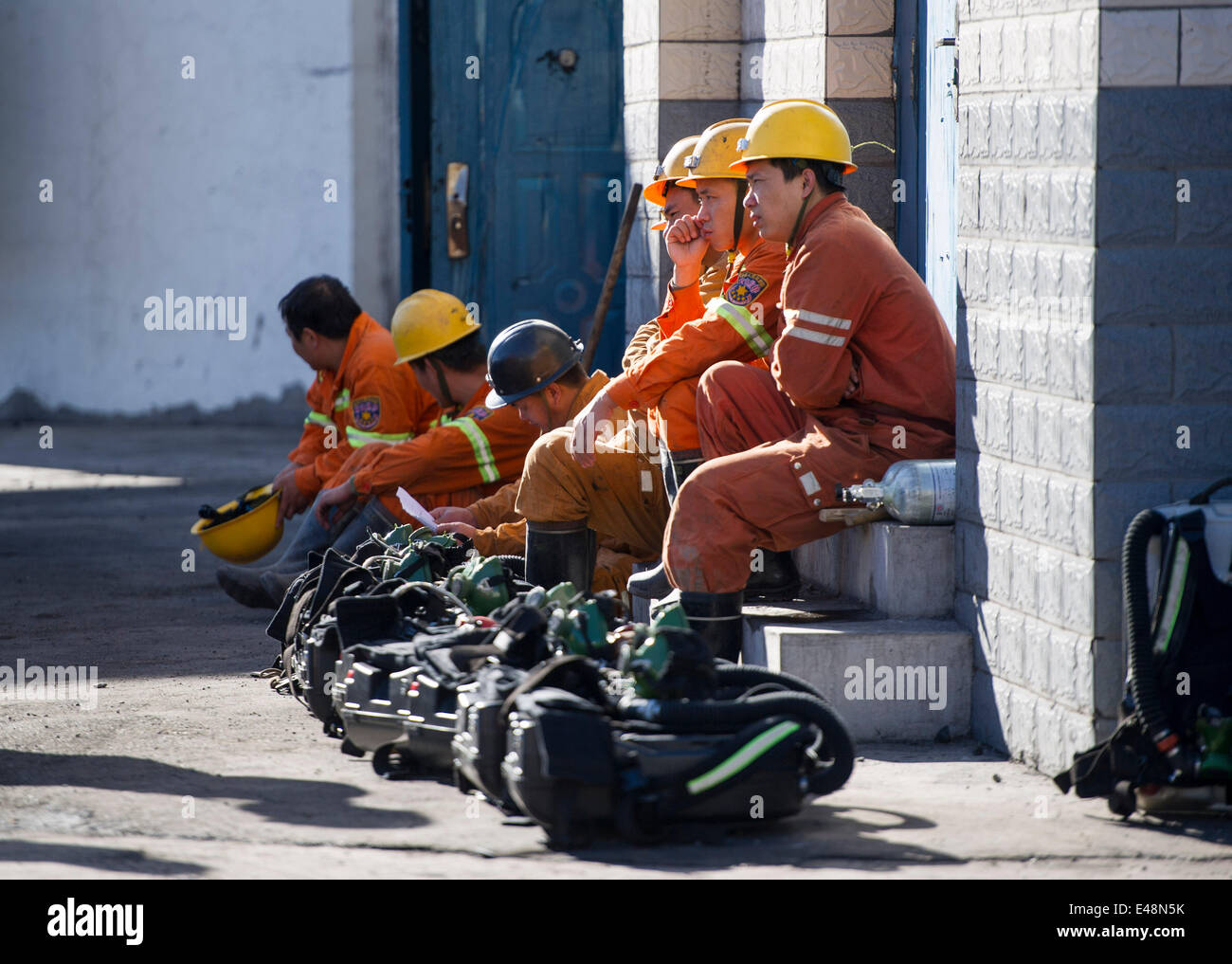 Fukang, China, 6th July, 2014.  Rescuers wait for work outside an entrance of the pit where a gas blast traps 17 miners at the No. 1 coal pit of Dhuangshan Yunxin Coal Mining Co., Ltd, 120 kilometers from Urumqi, capital of northwest China's Xinjiang Uygur Autonomous Region, July 6, 2014. The blast happened at 8:43 p.m. on Saturday, when 20 people were working inside the mine. Three of them have been rescued. Rescuers are pouring nitrogen into the mine to dilute the gas concentration. Credit:  Xinhua/Alamy Live News Stock Photo