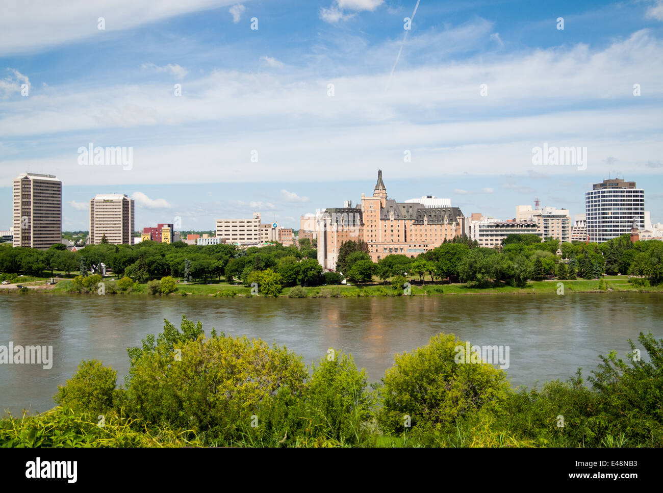 A view of the Delta Bessborough Hotel, South Saskatchewan River and the Saskatoon skyline.  Saskatoon, Saskatchewan, Canada. Stock Photo