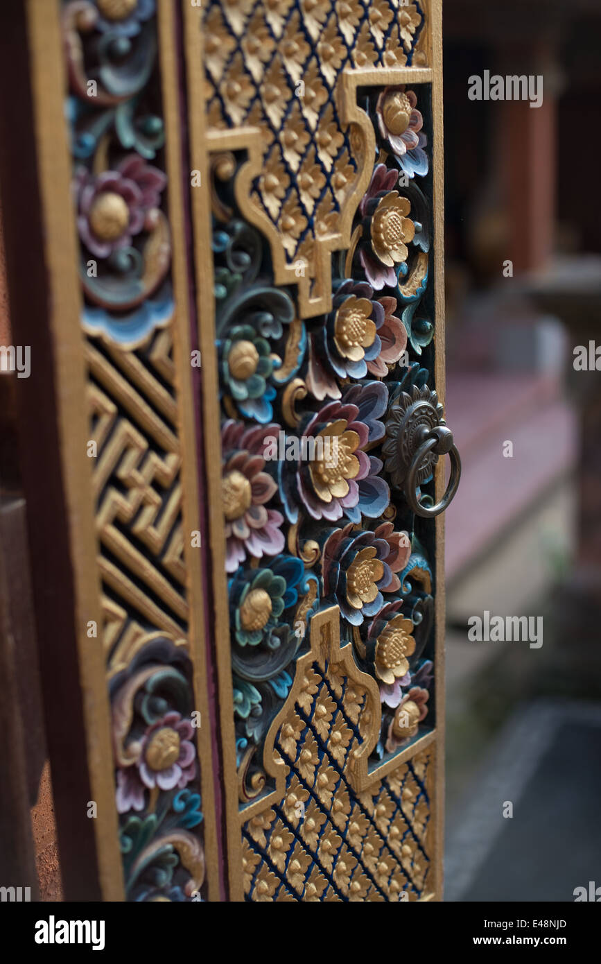 Intricate woodwork on a traditional door leading to a private premises Stock Photo