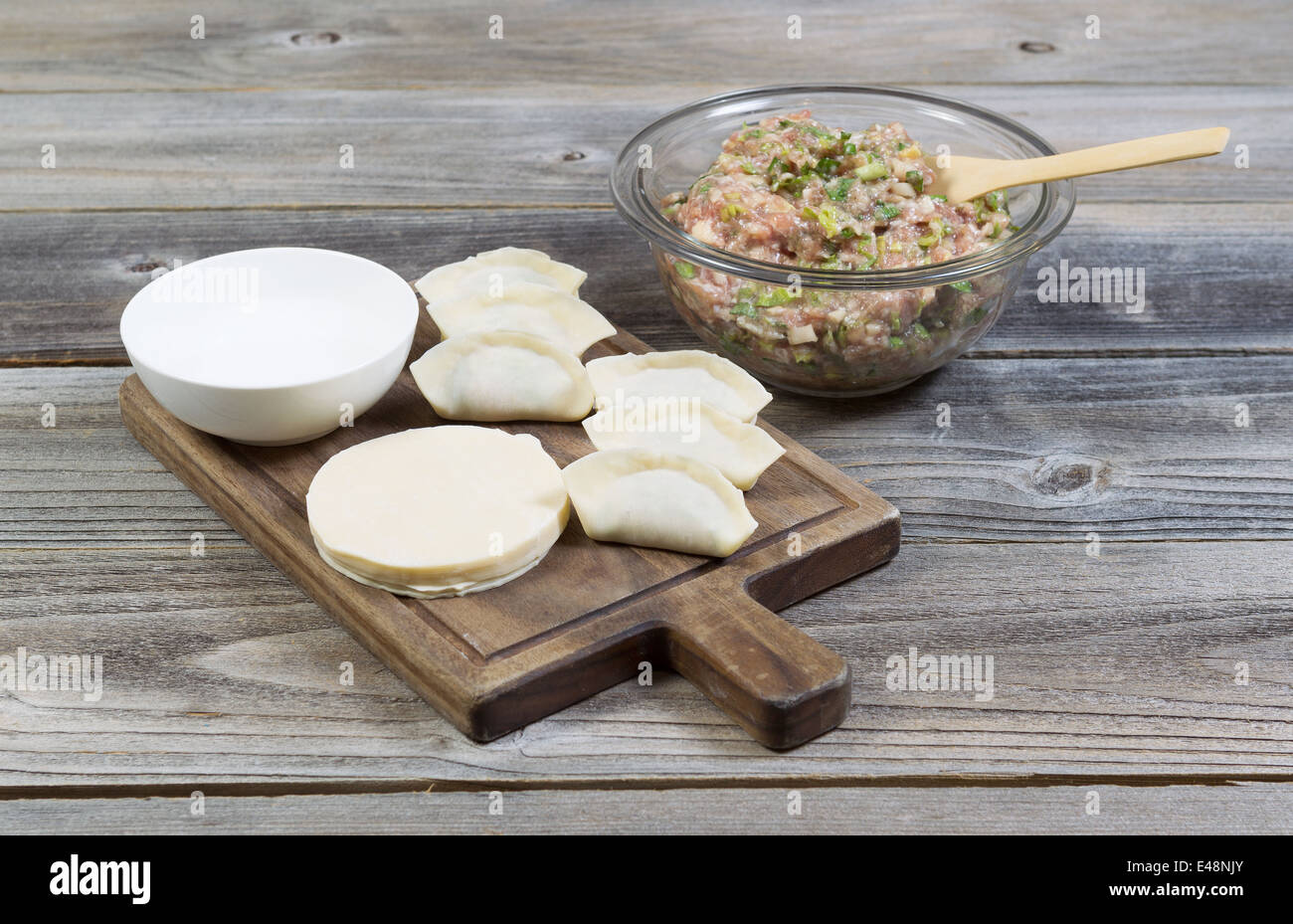 Horizontal photo of homemade traditional Chinese Dumplings being made from raw ingredients Stock Photo