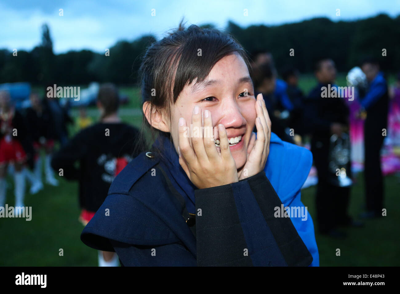 Rastede, Germany. 5th July, 2014. Cheng Yi, member of Beihang University's marching band, cries with joy after finishing their performance during the 59th International Rasteder Music Day in Rastede, Germany, on July 5, 2014. More than 50 bands and thousands of musicians from 6 countries and regions took part in the three-day International Rasteder Music Day, one of the oldest music festivals in Germany. Credit:  Zhang Fan/Xinhua/Alamy Live News Stock Photo