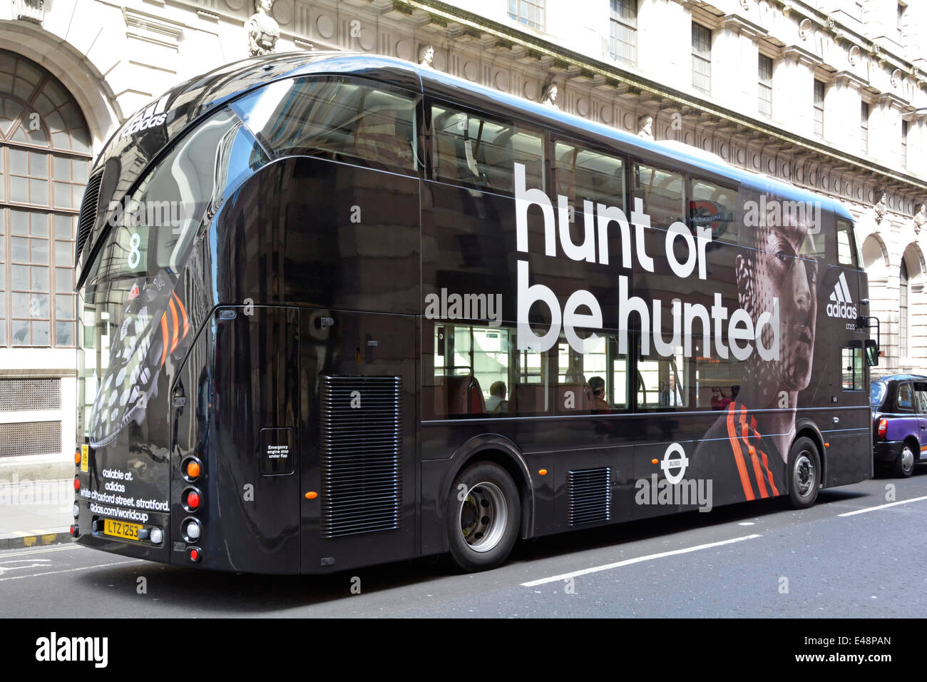 Adidas advertising on new London Routemaster Boris bus completely black  instead of red Stock Photo - Alamy