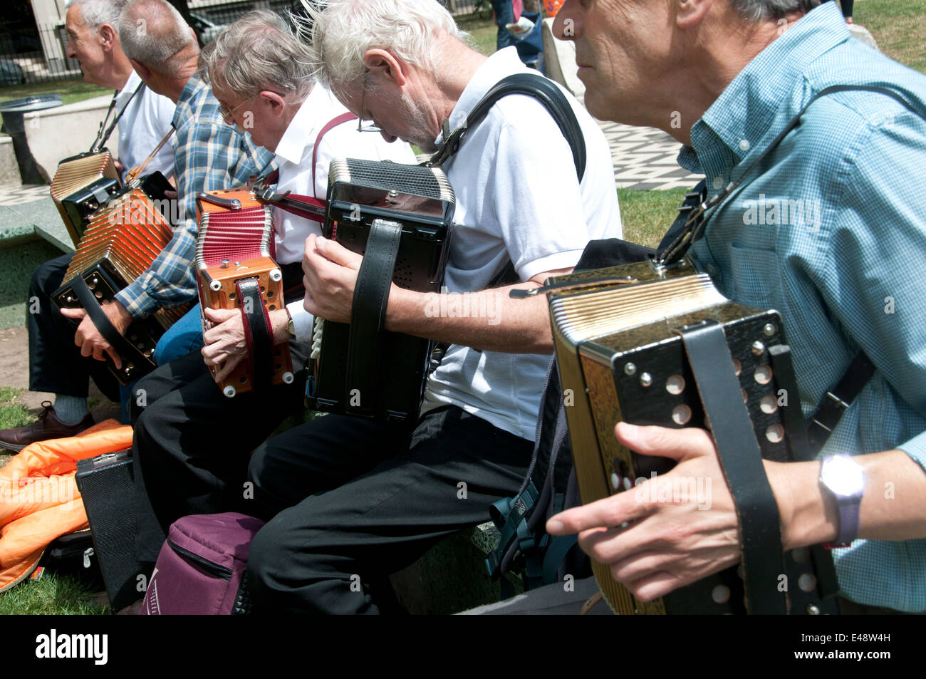Members of the Yardarm folk orchestra play melodeons and accordion in Altab Ali Park, Whitechapel, before the march. Stock Photo